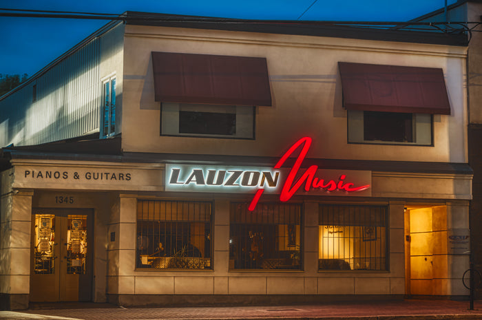 The Lauzon Music storefront at 1345 Wellington Street West at dusk, the red neon script lit above the windows